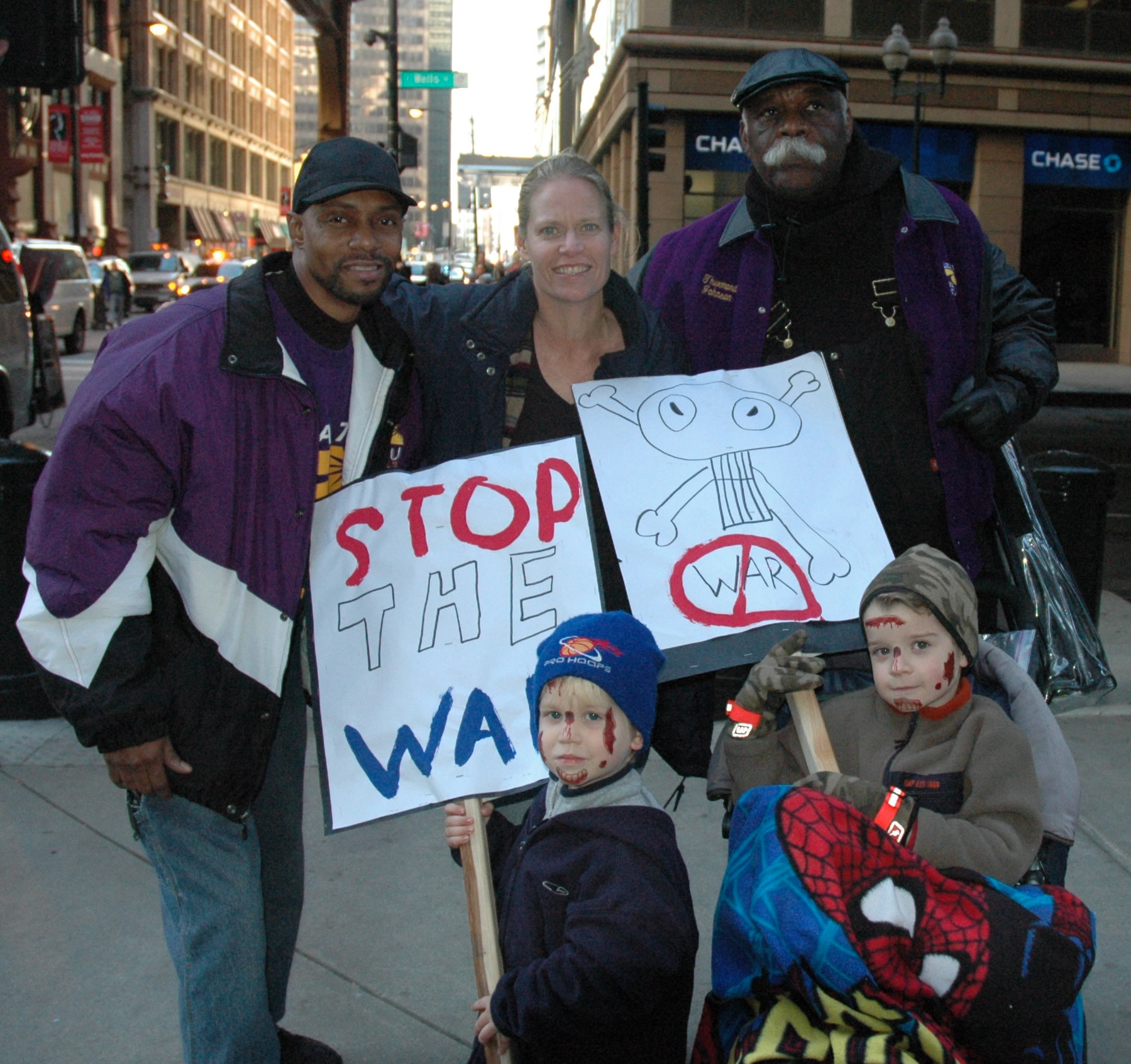 October 27, 2007: Members of the Service Employees International Union (SEIU) Local 73 contingent from the anti-war march join Sharon, Josh and Sam Schmidt under the “L” before heading into the federal plaza for the rally that ended the 10,000-person march. Hundreds of union members participated in the march, including large groups from SEIU, Unite HERE, and the electrical workers unions. Substance photos this page by George N. Schmidt.